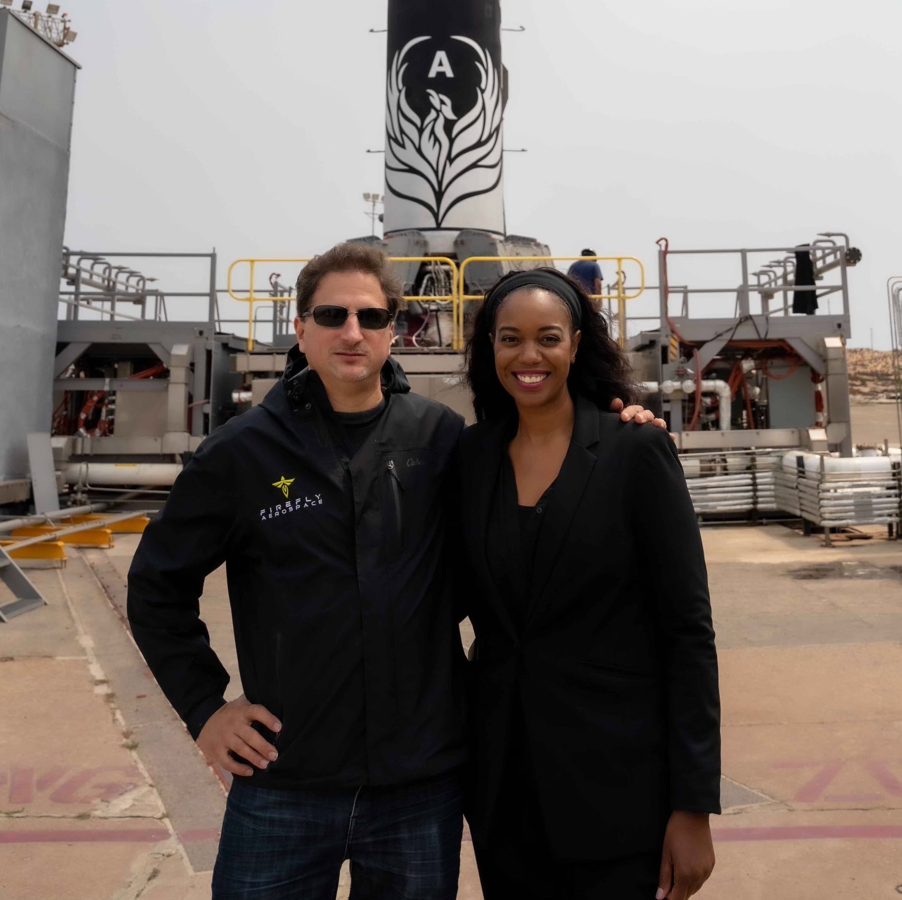 Tom Markusic and Lauren Lyons in front of Firefly Alpha rocket on the pad at Vandenberg Space Force Base (VSFB) (Photo: Business Wire)